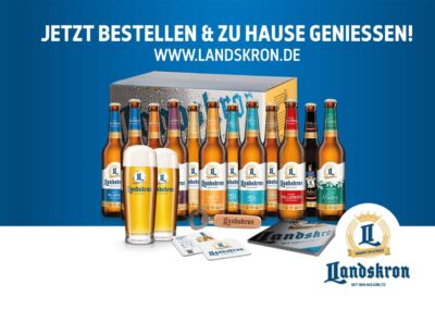 Werbeanzeige mit verschiedenen Flaschen der Brauerei Landskron, Slogan „Jetzt bestellen und zu Hause genießen“ – Hinweis auf regionale Getränkekooperation.